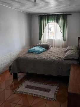 Room with window and made bed Stock Photos