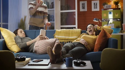 Roommates at home relaxing and getting bored Stock Footage 128778053