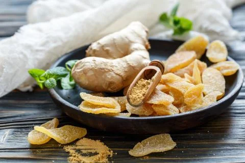 Root and ground ginger, spicy ginger candied fruit. Stock Photos