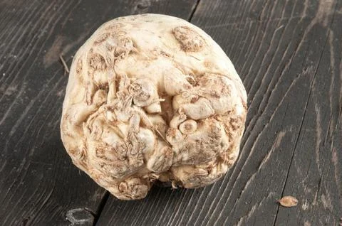 Root of Celery on a wooden table Stock Photos