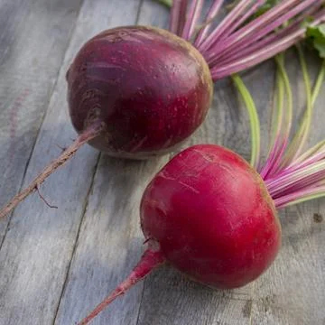 Root crops of two varieties of beets  on a wooden old table Stock Photos