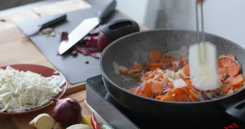 Root vegetable cooking in hot pan Stock Footage 146246195