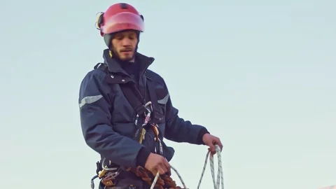 Rope access engineer abseiler with safety harness is working Stock Footage 125155873