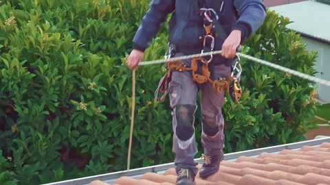 Rope access engineer wearing full body safety harness hardhat doing inspection Video stock 125156072
