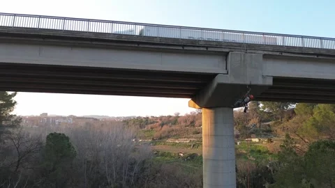 Rope access technician inspecting bridge infrastructure Stock Footage 306758277