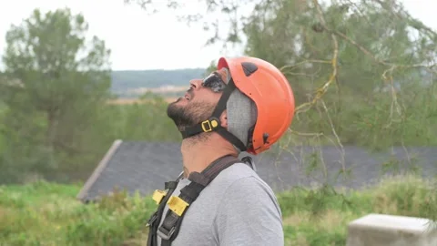 Rope access technician looking up while wearing safety helmet Stock Footage 302548527