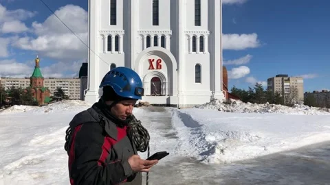 Rope access technician makes a phone call outside Stock Footage 235902888