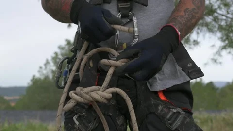 Rope access technician making safety knot for tree pruning Stock Footage 302246681
