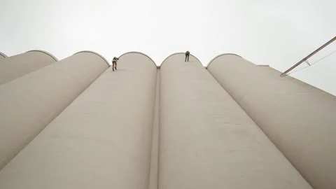 Rope Access Workers Abseiling Down Concrete Silos Stock Footage 346501186