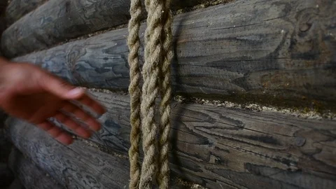 Rope against the background of a log wall, removes the rope Stock Footage 117046697