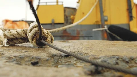 Rope and cable are tied from pier to barge Stock Footage 103354623