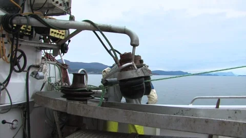Rope being pulled up by the boat equipment as the fisherman pulls his final Stock Footage 93556786