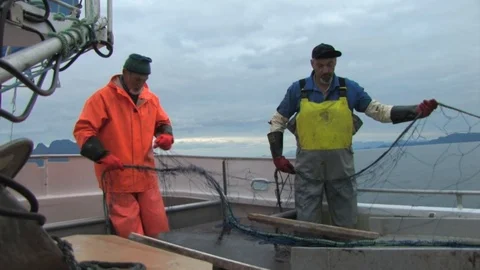 Rope being pulled up by the boat equipment as the fisherman pulls his Stock Footage 103530635