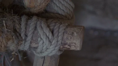 The rope being tied on the bamboo to be connected Видео 79897945