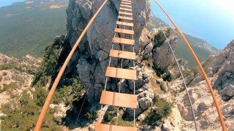 Rope bridge.The transition between the rocks.Extreme tourism. Stock Footage 95400786
