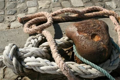 A rope, a cable, by which a sea ship is attached to a quay, tied up by a sea  Stock Photos