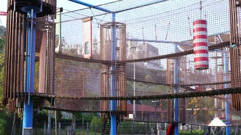 Rope climbing playground structure with safety nets and colorful obstacles Stock Footage 321008097