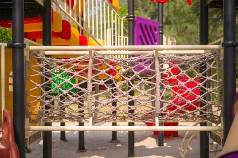 Rope crawl pipe labyrinth on modern kids playground Stock Photos