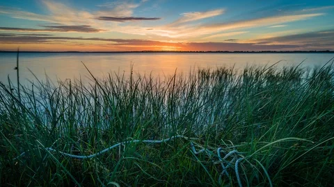 Rope in the grass in front of Lake Colac at sunset, zoom in Stock Footage 99455802