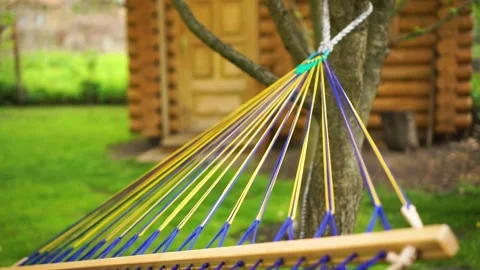 Rope hammock strings hang on tree. Summer rural wooden cottage yard Vídeo Stock 243939215