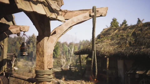 Rope hanging from a wooden structure in a rustic village setting Stock Footage 329211857