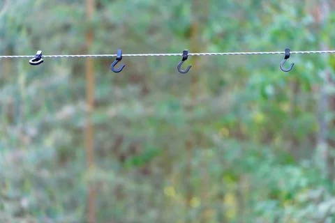 A rope with hooks for drying clothes during a hike is stretched between the t Foto stock