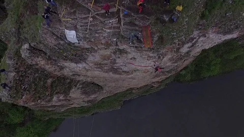 Rope jumping from high mountains, over the river Stock Footage 76181800