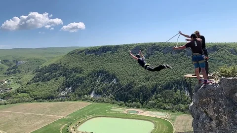 Rope jumping. A man jumps with a rope from a cliff. Stock Footage 108104575