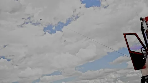 Rope to launch a glider with a parachute falls to the ground Stock Footage 238421814