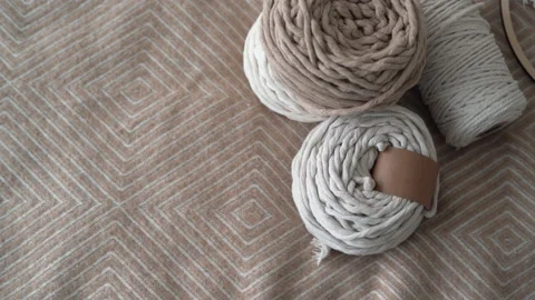 Rope for macrame, Weaving macrame. Balls of twine for weaving are thrown onto Stock Footage 152976410