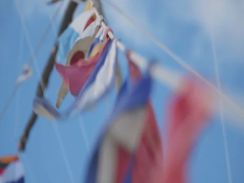 Rope with many small flags flutter on wind. Soft clouds at sky Stock Footage 104675131