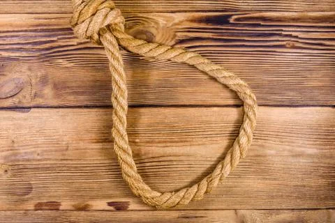 Rope with noose for the suicide on wooden background Stock Photos