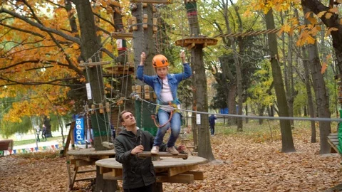 Rope Park. A young instructor helps a little girl. Stock Footage 113383882