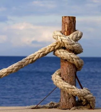 Rope on seafront and cloudy sky in autumn evening Stock Photos