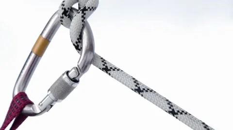 The rope slides through the carabiner Stock Footage 60844110