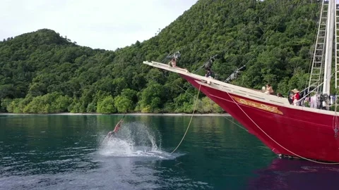 Rope Swing Fun Flip of the Front of Sail Boat Tropical Holiday in Raja Ampat Stock Footage 197059490