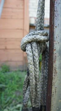 A rope tied to an iron pipe, hanging in the yard Stock Photos