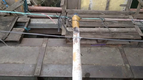 The rope tied to the iron pole, which is above the water channel Stock Footage 142246132