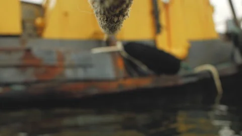 The rope is tied to an old rusty ship Stock Footage 103354621