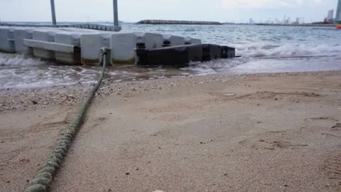 Rope tightening plastic container platform serve as walking bridge from sea Video stock 258885521