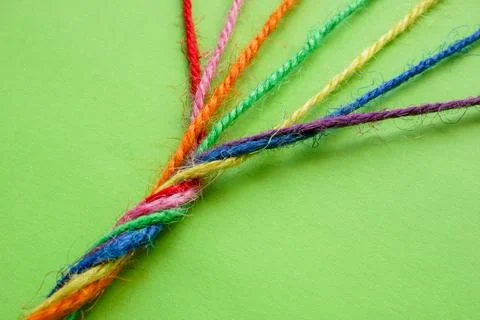 Rope twisted from multicolored threads. Unity and diversity. Stock Photos