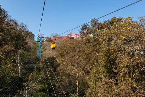 Rope way through green forests to mountain top 스톡 사진
