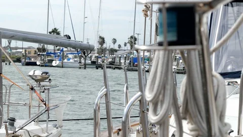 Ropes and other rigging of a sail boat docked in a marina. Selective focus. Stock Footage 129266655