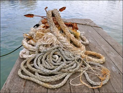 Ropes and rusty anchor Stock Photos