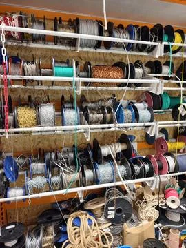 Ropes cables and chains arranged in structured coils and bobbins on store s.. Stock Photos