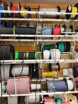 Ropes cables and chains wound into tidy coils and bobbins in a construction.. Stock Photos