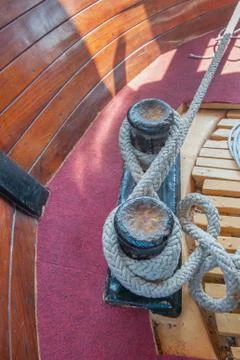 Ropes on the device for fixing the ship to the pier. Details of the ship. Stock Photos