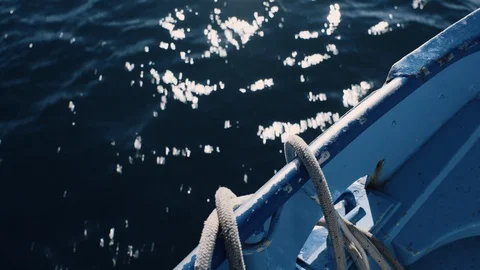 Ropes hanging off side of boat while sailing Stock Footage 128699656