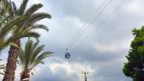 Ropeway cabin on the background of palms and clouds Stock Footage 92271183