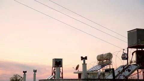 Ropeway, cable car cabin move towards each other against backdrop of orange and Video stock 226195301